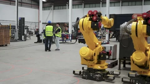 Industrial workers working inside automation and robotics facility - Industry  Stock Footage 202090090