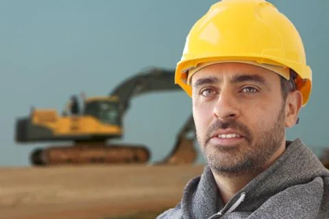 Industrial workman in a hat hat Stock Photos
