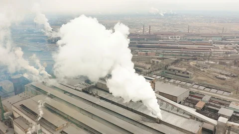 Industrial zone with a large red and white pipe thick white smoke is poured from Stock Footage 102695129