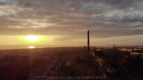 Industrial zone with a large red and white pipe thick white smoke at sunset Stock Footage 104301855