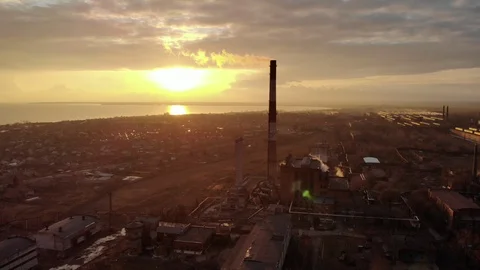 Industrial zone with a large red and white pipe thick white smoke at sunset Stock Footage 104301936