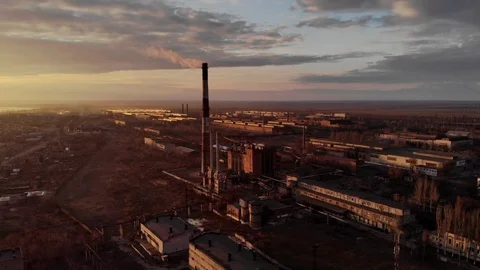 Industrial zone with a large red and white pipe thick white smoke at sunset Stock Footage 104302090