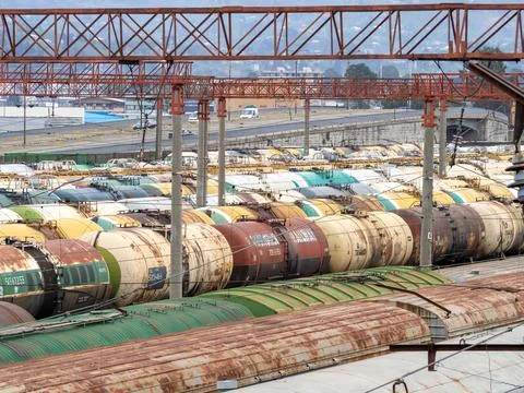 Industrial zone. Loading station. Train wires. Fuel tanks. Cars at the statio Stock Photos