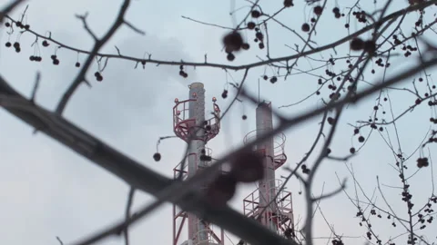 Industrial zone with a two red and white pipe white smoke is poured from the Video stock 169439804