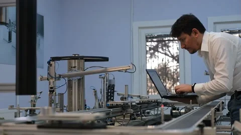 Industry 4.0 concept; Engineer is working on laptop to program smart factory Video stock 132863227
