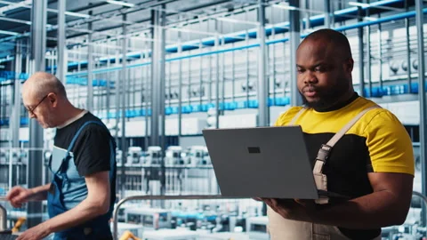 Industry 4.0 industrial plant engineer automating robotic machines using AI Stock Footage 305483431