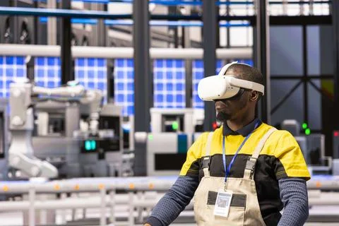 Industry 4.0 technician using virtual reality for industrial training Stock Photos