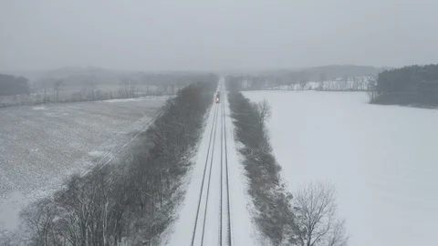 Industry - Aerial View of Passing Train While Snowing - 4K Aerial Realtime Video stock 98960207
