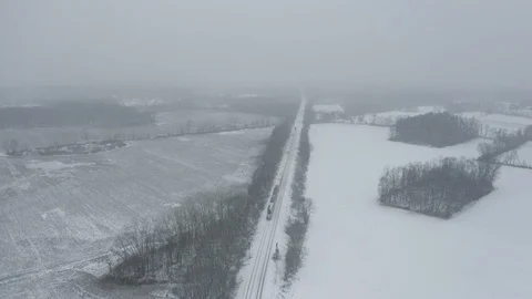 Industry - Aerial View of Passing Train While Snowing 2 - 4K Aerial Vidéo 99004876