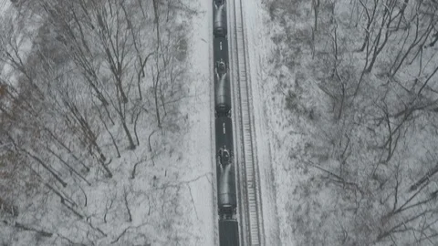 Industry - Aerial View of Passing Train Tilt Up - 4K Aerial Realtime Video stock 99120466