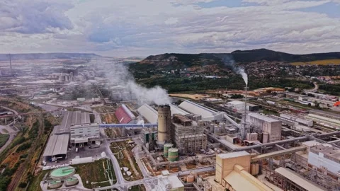 Industry complex with smoke and machinery in an open landscape Stock Footage 339649726