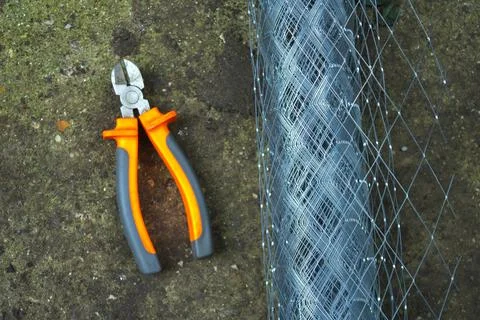 Industry construction site worker pliers and wire mesh grid Stock Photos