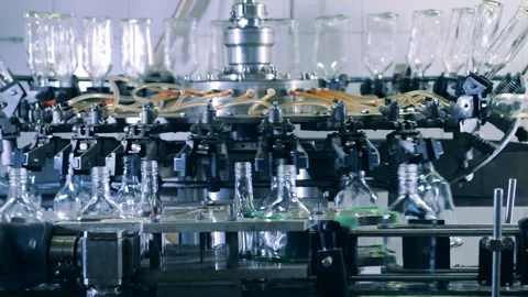 Industry Machine Process. glass water bottles spin rotating and filling. Stock Footage 334587929