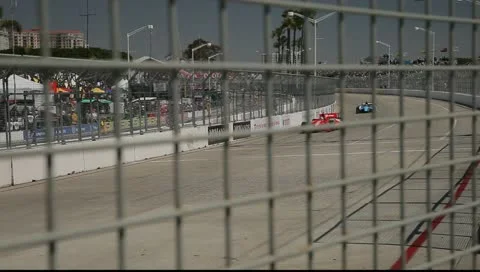 Indy Cars Racing Through Fence Stock Footage