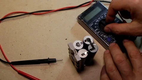 Ineffective measurement of the voltage of bad batteries Stock Footage 90803378