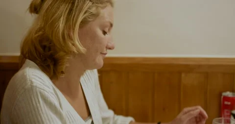 Ines Vau sitting at table with Hugo Vau and drinking coffee in restaurant Stock Footage 156032280