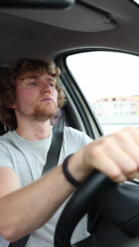 Inexperienced driver hesitates while carefully handling a car in urban traffic Stock Footage 342919722
