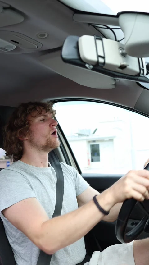 Inexperienced driver holds the wheel with both hands and carefully turns the car Stock Footage 342922838