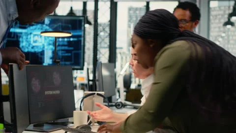 Inexperienced intern in office requests help from team to fix hacking attempt 스톡 동영상 323331998