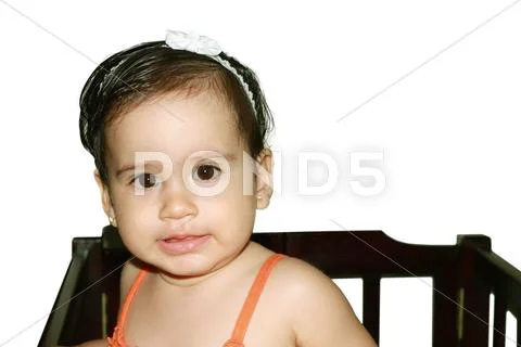 Infant baby playing in her little baby bed at nursery. Stock Photos