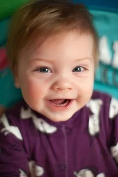 Infant in bed with first teeth smiling Stock Photos