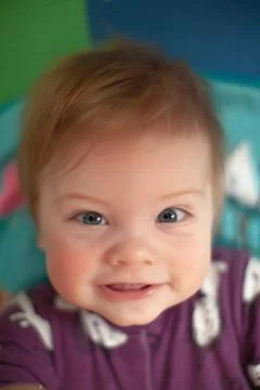 Infant in bed with first teeth smiling Stock Photos