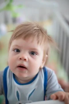 Infant in bed staying Stock Photos