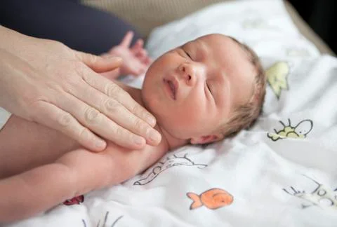 Infant being caressed Stock Photos