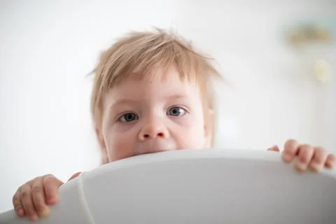 Infant biting in the bed Stock Photos