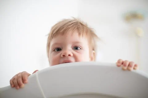 Infant biting in the bed Stock Photos