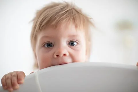Infant biting in the bed Stock Photos