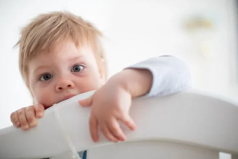 Infant biting in the bed Stock Photos