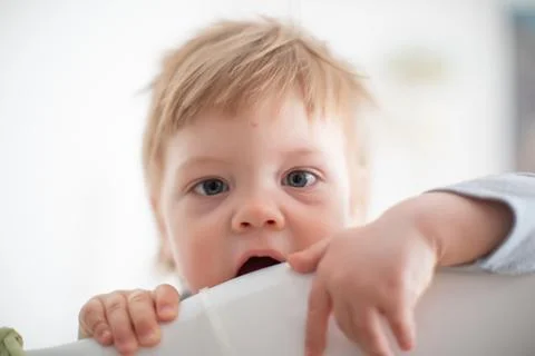 Infant biting in the bed Stock Photos