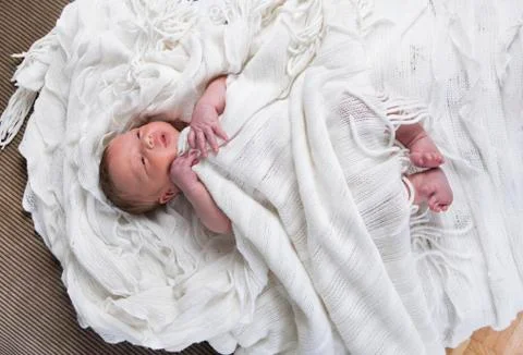 Infant with blanket in bed Stock Photos