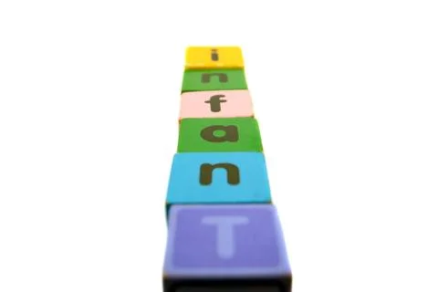 Infant in blocks on white background Stock Photos