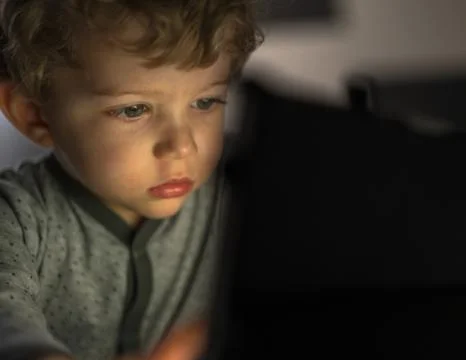 Infant boy watching an tablet Photos