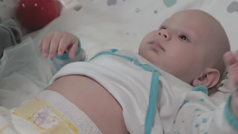 An infant is changing diapers.The child is lying on his back.Close-up.Mom's hand Stock Footage 163660275