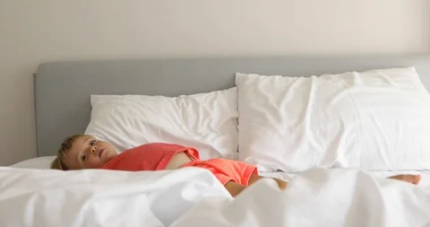 Infant child on white bed Stock Footage 103272401