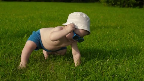 Infant crawls on grass Stock Footage 291892921