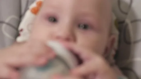 An infant eats baby formula from a bottle. Feeding a baby close-up.baby.Baby's h Stock Footage 163660229