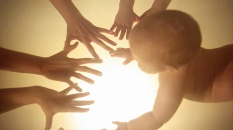 Infant exploring and touching fingers of her mother and older sisters. Stock Footage 44561588