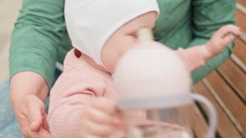 Infant Extends Hand Towards Favorite Pacifier In Park Setting, Eager Baby On 動画素材 327032559