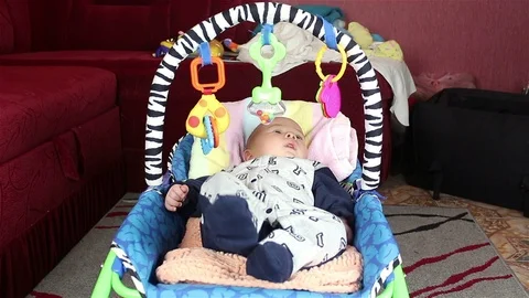 Infant lying in bed and playing. Video stock 72757616