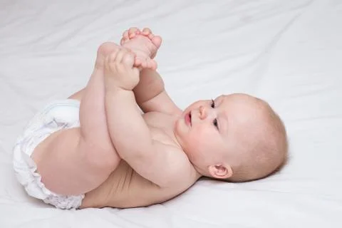 Infant lying on a changing table at home Stock Photos