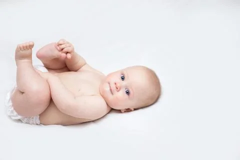 Infant lying on a changing table at home Stock Photos