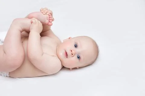 Infant lying on a changing table at home Stock Photos