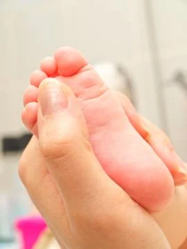 Infant massage Stock Photos