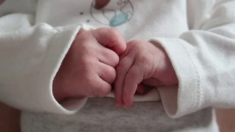 Infant Newborn Baby Hands Close-up in front of Chest - Day - 60fps Stock Footage