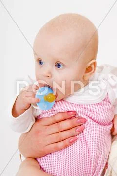 Infant with a pacifier Stock Photos