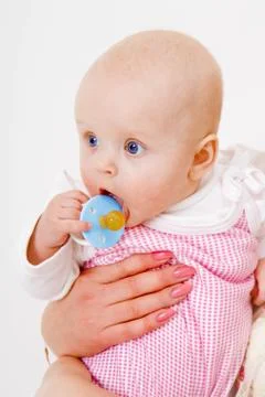 Infant with a pacifier Stock Photos